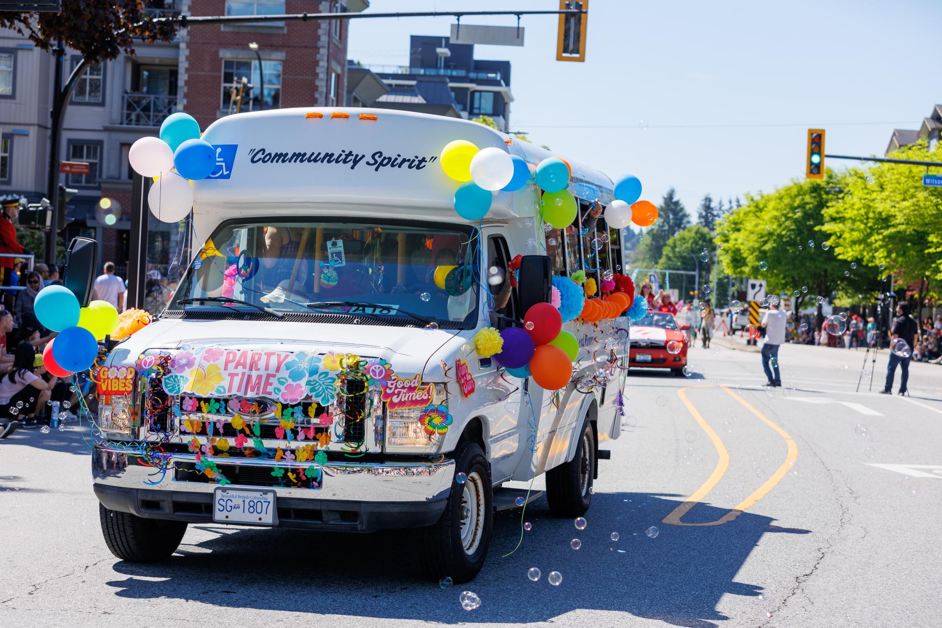 Bus covered in balloons participating in the May Day Parade