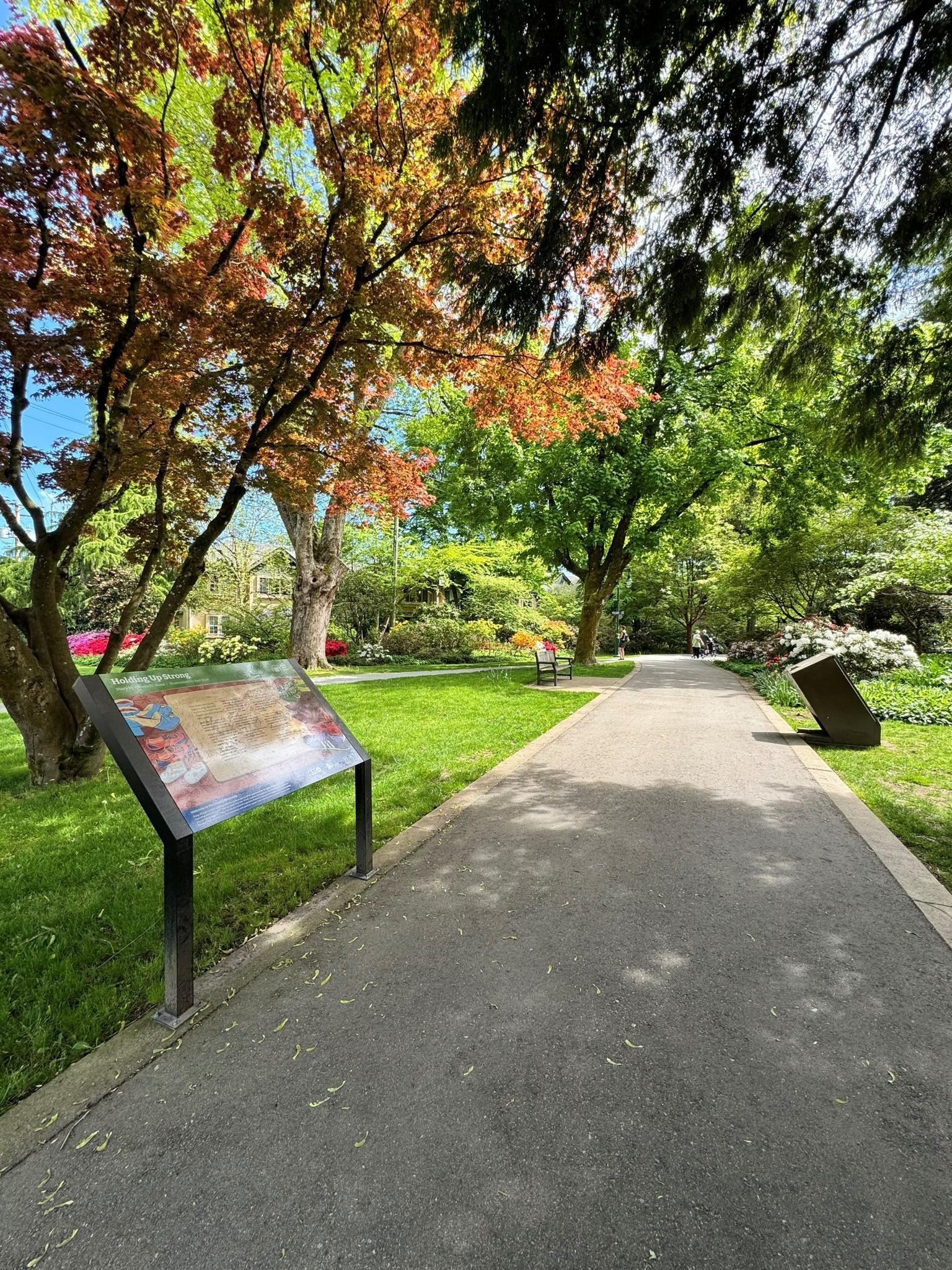 Donald Storywalk pathway with a panel and trees and flowers
