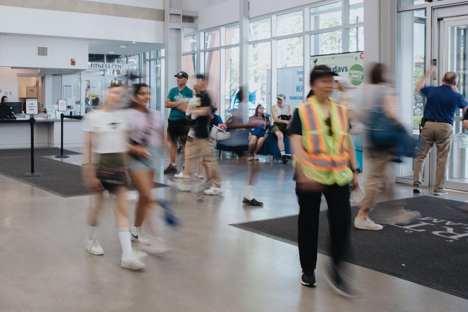 people walking through port coquitlam community centre