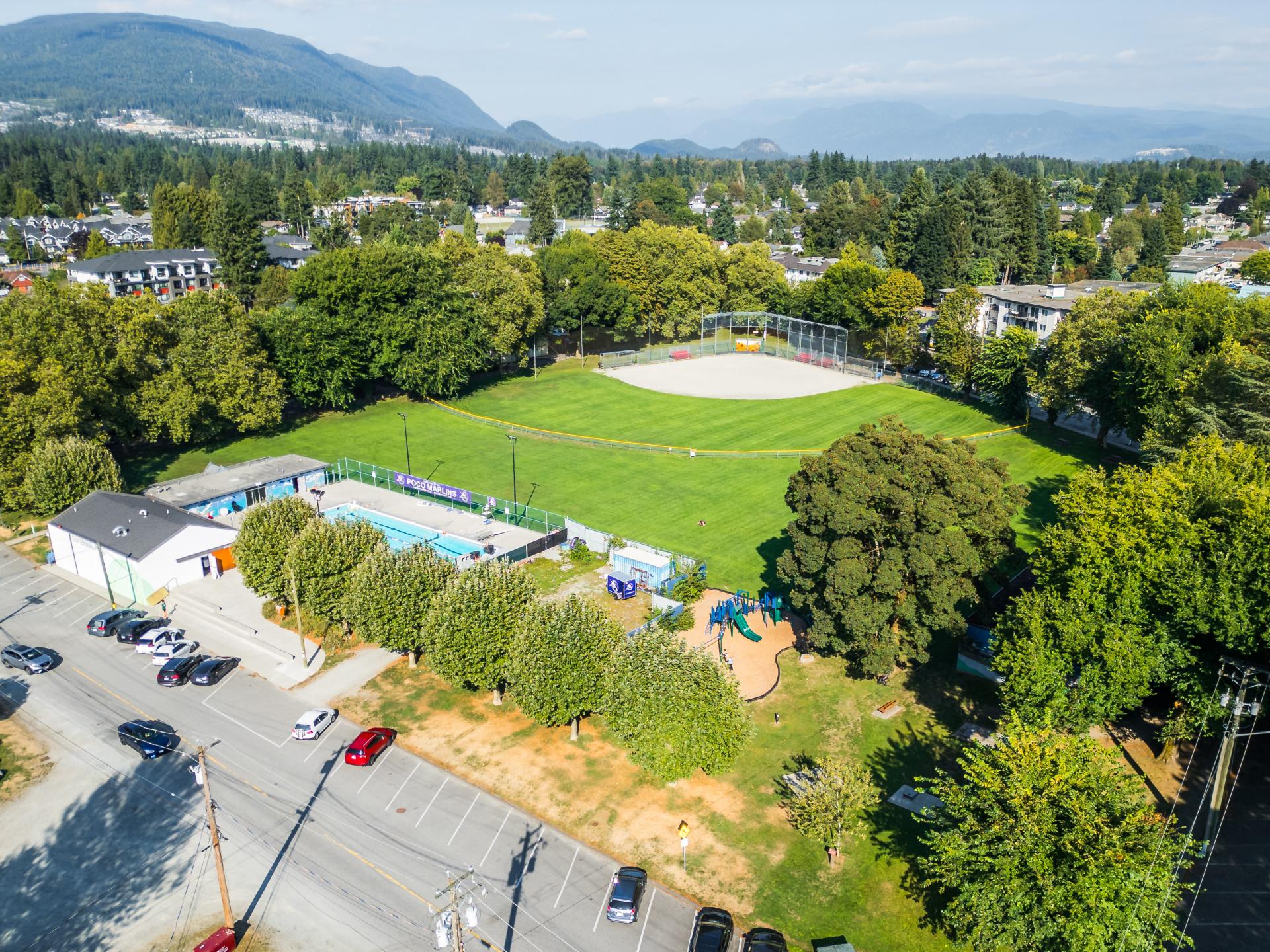 Aerial view of Aggie Park featuring grass field, outdoor pool, and baseball diamond