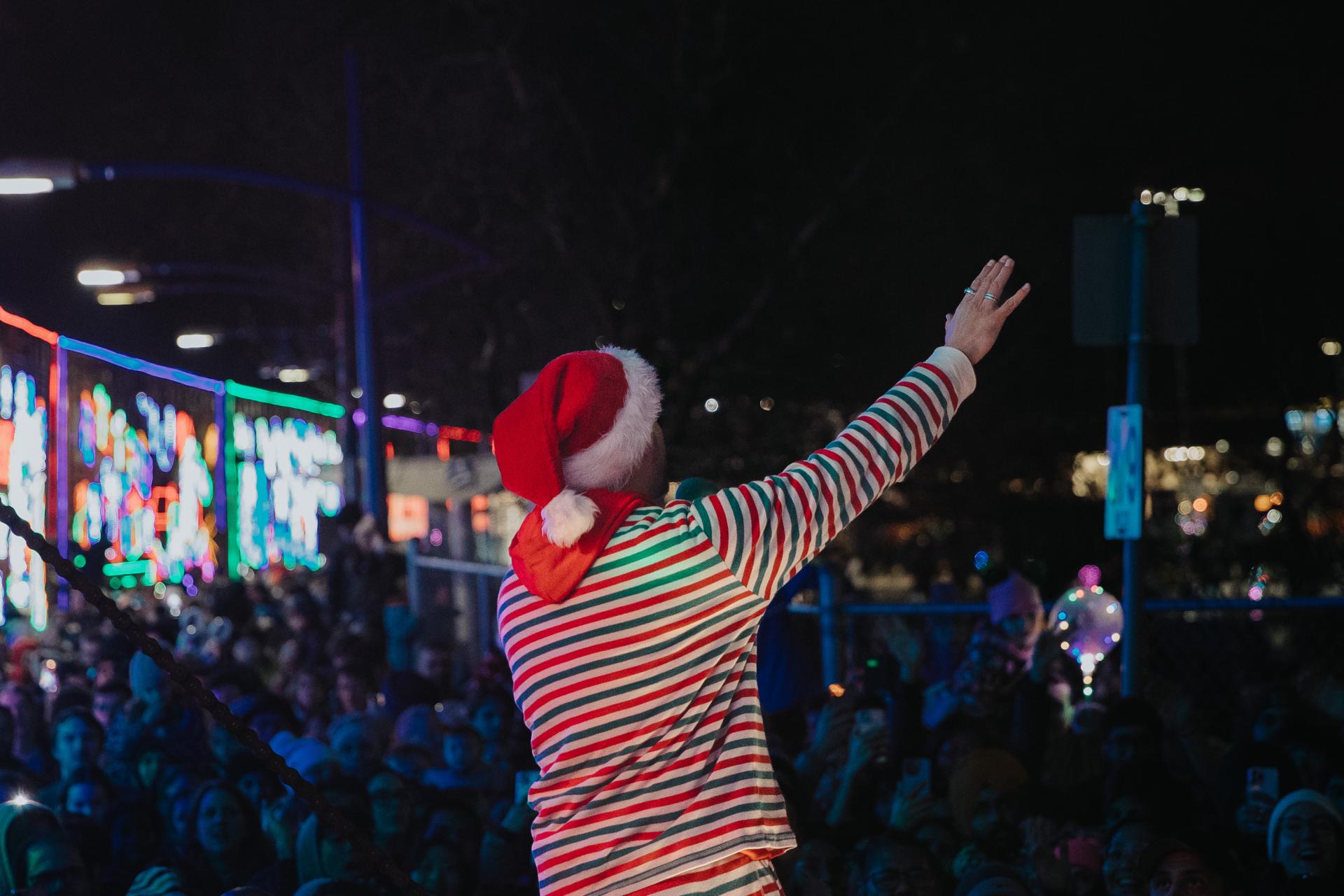 performer waving to crowd from holiday train