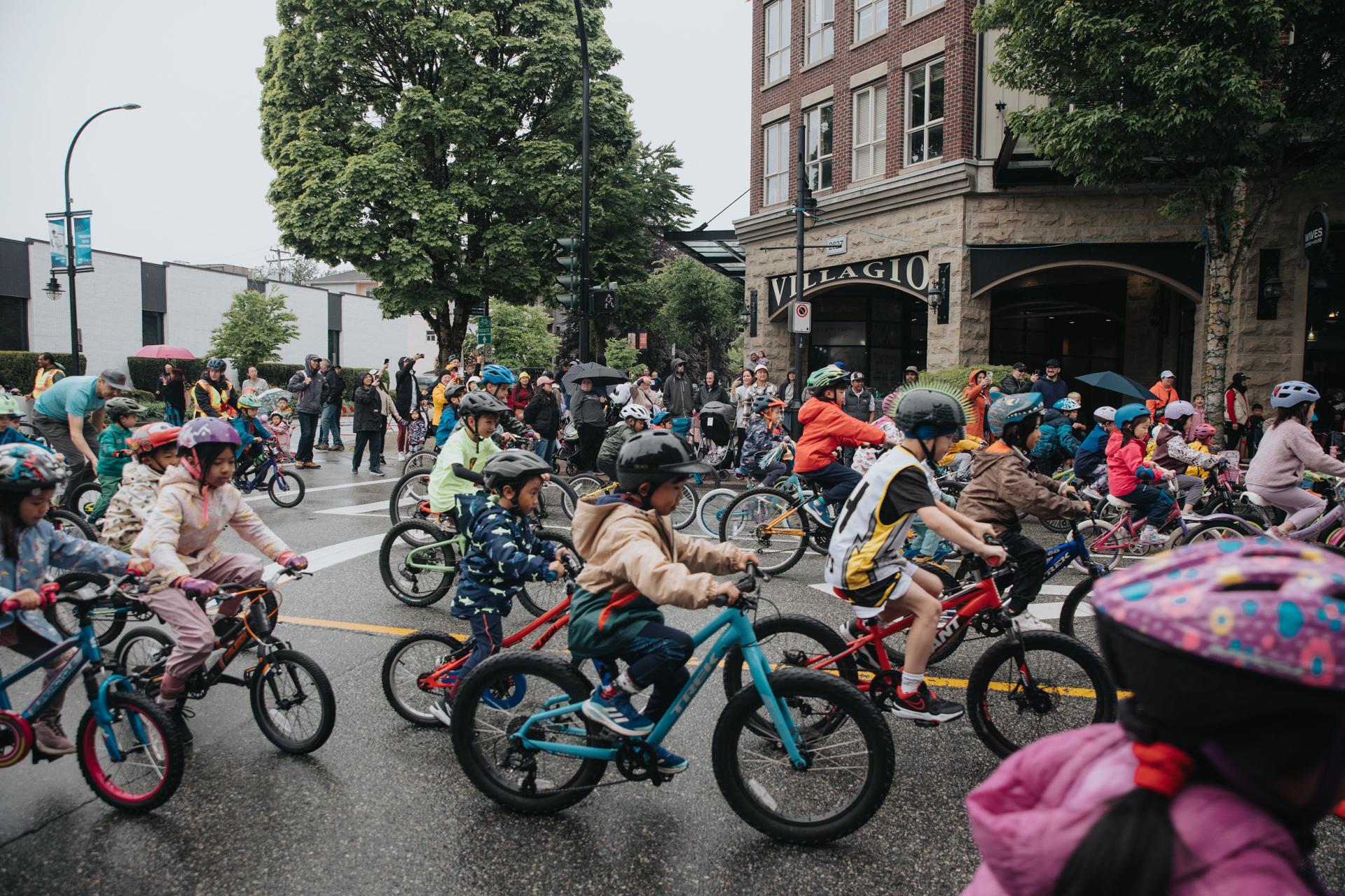 kids doing a street bicycle race downtown poco