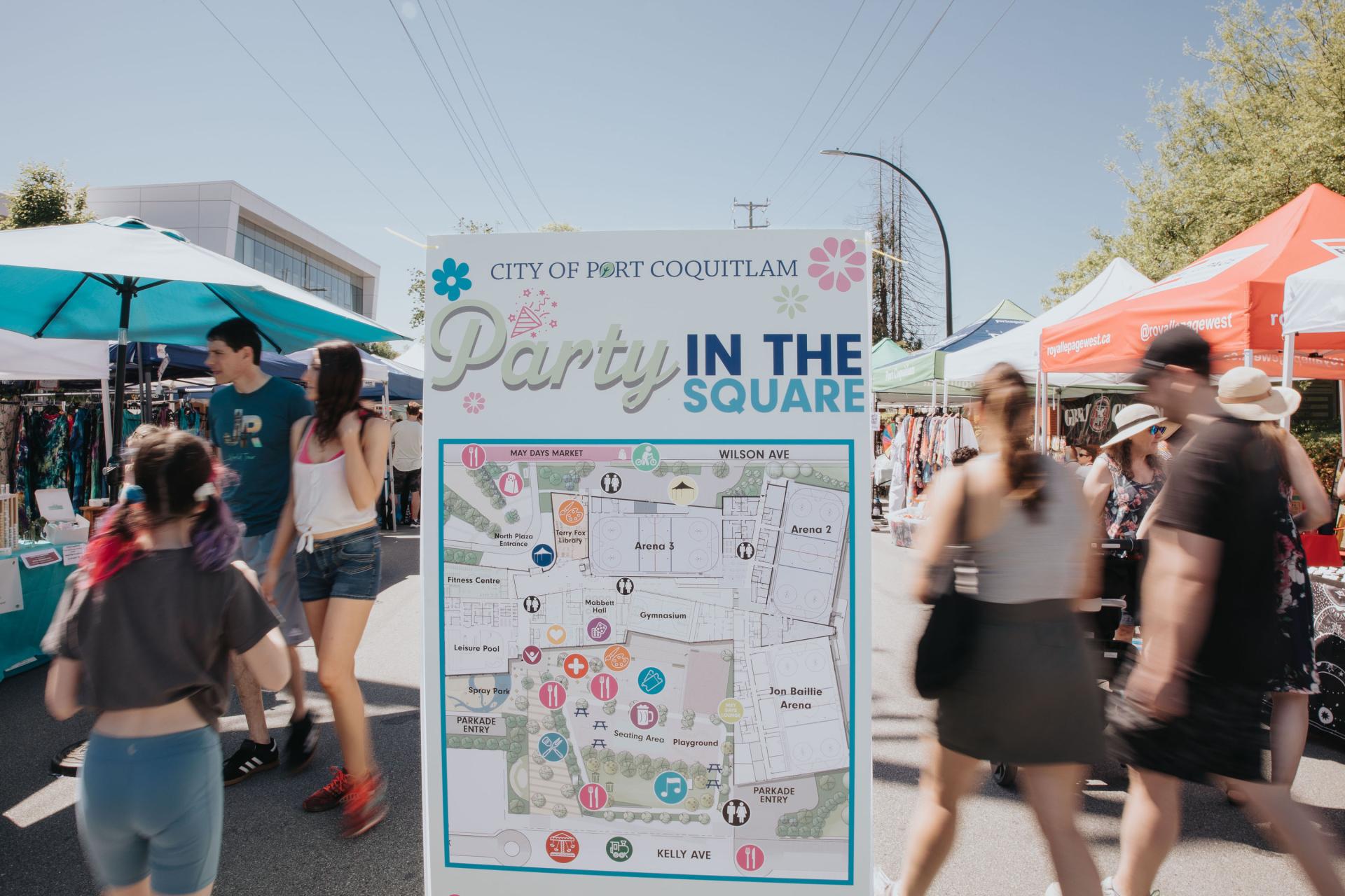 people walking through street festival