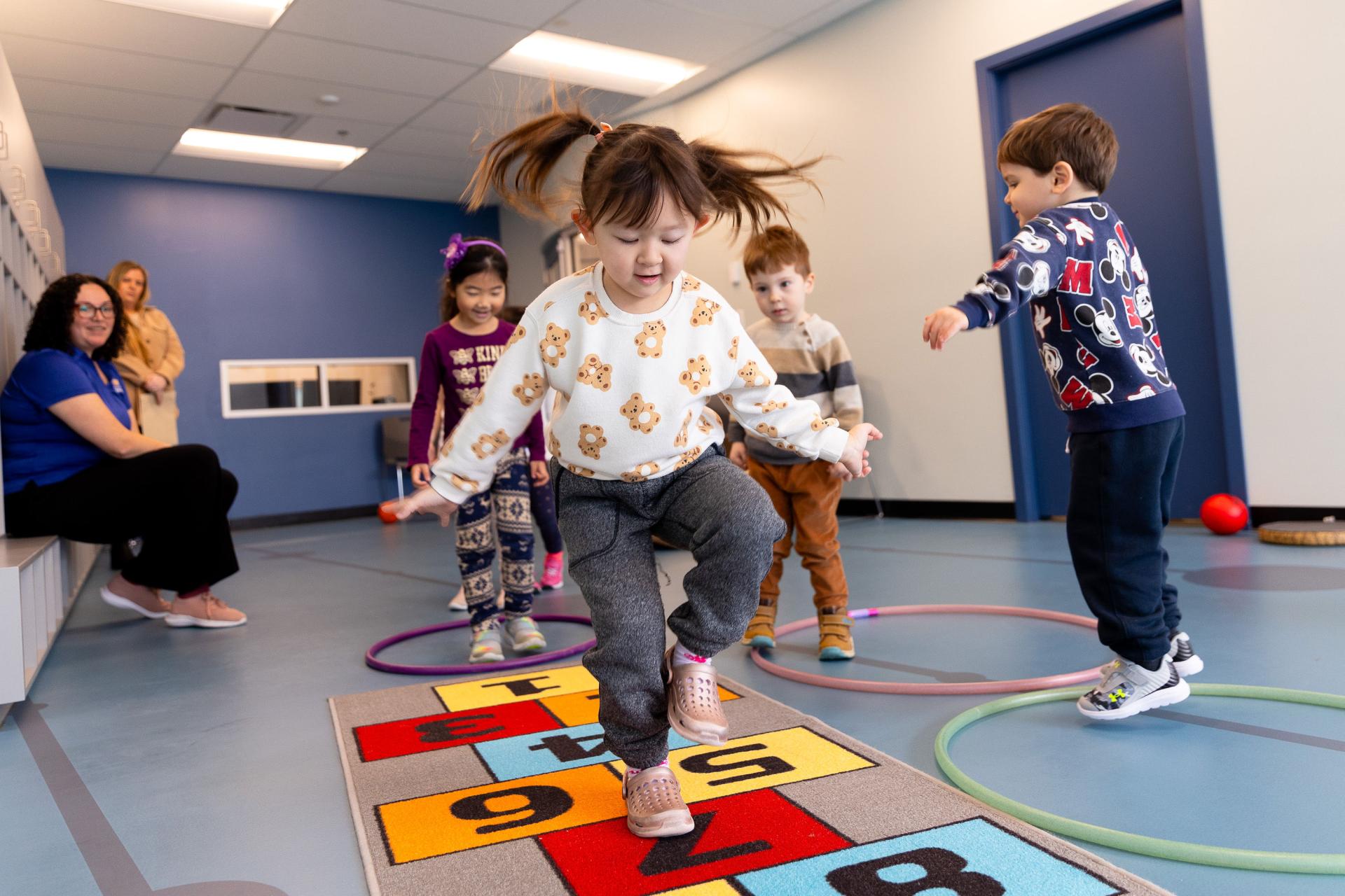 child playing hopscotch indoors